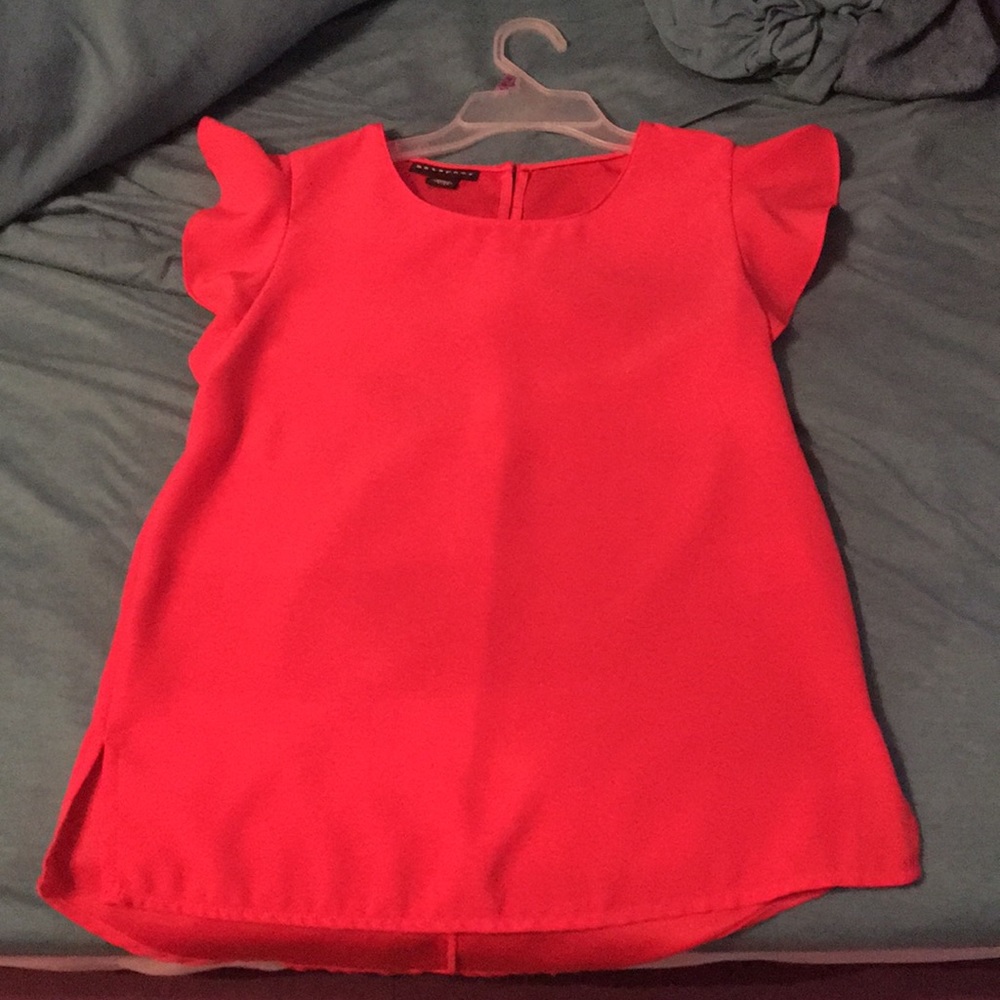 Pinky-Coral blouse with butterfly sleeve detail.